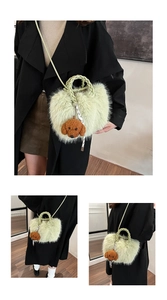 Detail of light green plush handbag with woven handle and cute brown puppy pendant charm