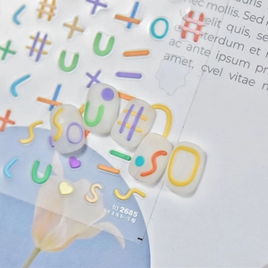 Macro detail of 5D embossed nail stickers with macaron letters and wave lines