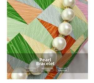 Detailed macro view of large white pearls with gold diamond-encrusted spacers on bracelet