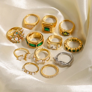 Set of gold and silver stainless steel rings with pearls and emeralds on silk