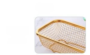 Close-up of golden rectangular stainless steel mesh basket with fine drainage holes
