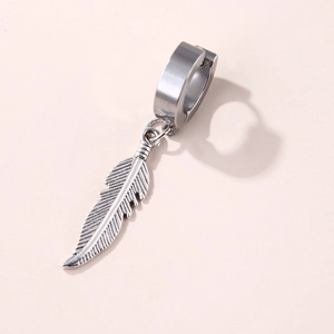 Macro view of stainless steel hoop earring with a detailed silver feather pendant