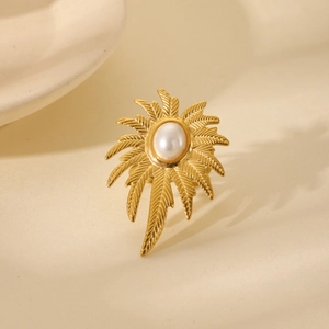 Detail of gold leaf texture and white pearl inlay on adjustable stainless steel ring