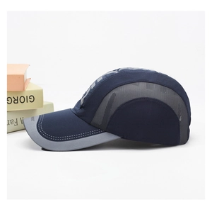 Detail of breathable grey mesh panels and stitching on a navy blue outdoor sports cap