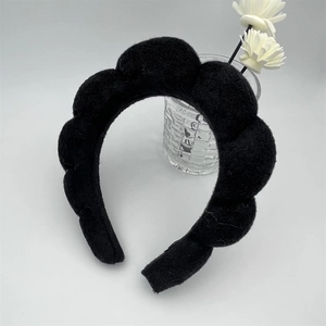 Detail of a thick black sponge headband for skincare with soft towel fabric texture