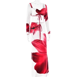 Detail of red floral print skirt set featuring drawstring ruched top and matching maxi skirt