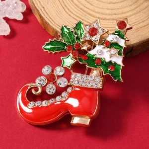 Festive Christmas brooch featuring a red enamel boot with a jeweled green Xmas tree