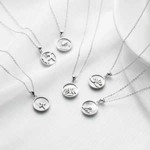 Set of six stainless steel necklaces with shell pendants featuring various artistic patterns