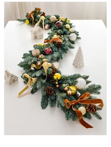 Close-up of 135cm lush Christmas garland with pine cones, golden balls and red bows
