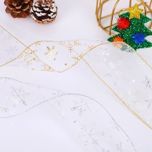 Christmas sheer ribbon with gold and silver snowflakes for festive gift wrapping