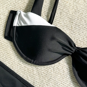 Detail of black and white bikini top with underwire support and fine stitching