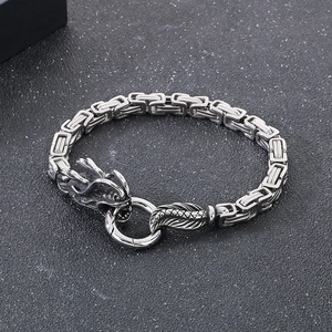 Detail of vintage silver dragon head bracelet with square box chain and spring clasp