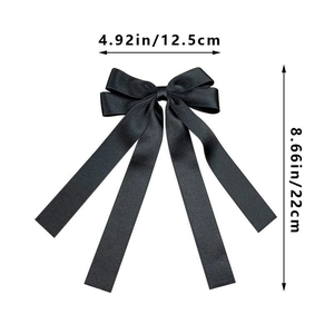 Detail view of black satin bow hair clip with ribbons showing dimensions 12.5x22 cm