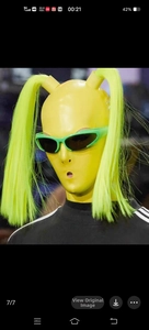 Detail of neon green ponytail decor on yellow futuristic cat eye cycling sunglasses