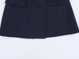 Detailed view of dark blue blazer hem featuring straight stitching and flap pocket detail