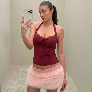 Detail of burgundy lace halter top with bow and pink faux fur mini skirt set