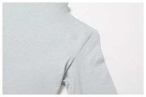 Close-up of shoulder stitching on a light grey quick-dry athletic compression top