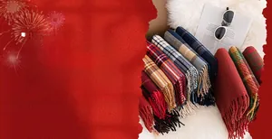 Detailed view of various winter plaid scarves with soft fringes and rich color patterns
