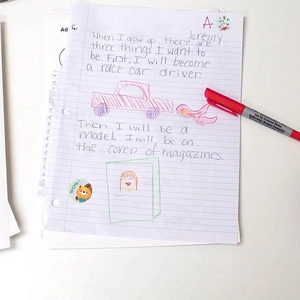 Round animal reward stickers for students and kids with red marker on handwriting paper