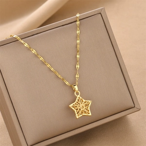 Hollow star pendant necklace in gold finish displayed on a brown jewelry box
