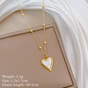 Detail view of gold heart necklace with shell inlay showing dimensions and 3.2g weight