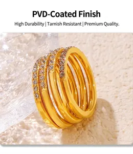 Macro shot of 18K gold plated PVD rings with set cubic zirconia on textured background
