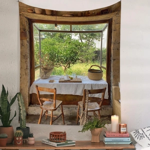 Detail of vintage garden window tapestry hanging over shelves with potted plants
