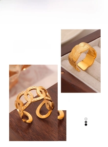 Close-up of gold-plated woven texture and hollow chain adjustable rings on velvet