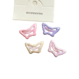 Set of 4 cute butterfly hair clips in pastel pink and purple for girls' hair styling