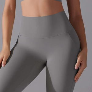 Close-up of dark grey high-waisted yoga pants showing seamless abdominal support and stitching