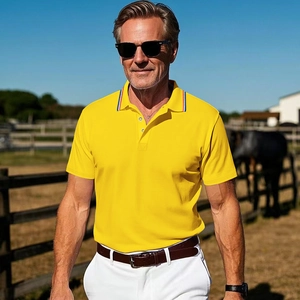 Close-up of a yellow polo shirt with striped collar detail in an outdoor equestrian setting