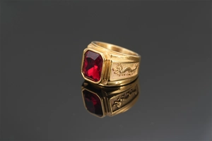Detail of golden dragon ring for men featuring a square red ruby gemstone inlay