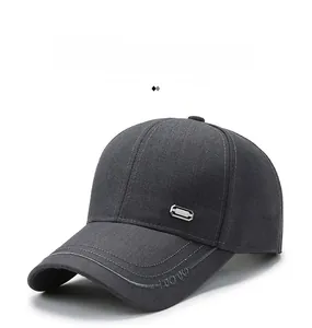 Detail of dark grey baseball cap featuring silver metal logo and double-stitched embroidered brim