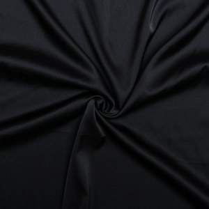Close-up of elegant black silk-like fabric with smooth texture and soft glossy sheen
