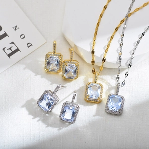 Detailed view of luxury square zircon pendant and earrings set in gold and silver finish