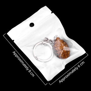 Tiger eye stone hand grenade keychain charm in transparent packaging with size details