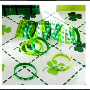 Detail of St. Patrick's Day silicone bracelets with shamrock patterns in green and white