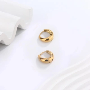 Minimalist 18K gold plated stainless steel U-shaped hoop earrings on white decor