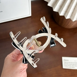 Elegant large acetate bow hair claw clip with deer antler design and metal spring