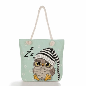 Detail of light green tote bag with jute rope handle and cute sleeping owl print