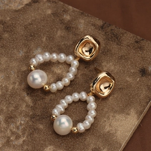 Elegant S925 silver needle drop earrings with natural pearls and golden hammered metal texture