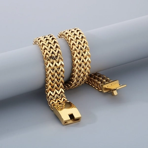 Detail of gold woven curb chain with heavy interlocking links and a secure clasp closure