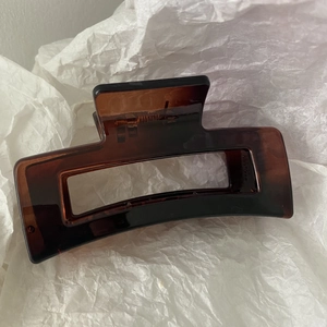Close-up of large brown tortoiseshell hair claw clip with rectangular cutout design