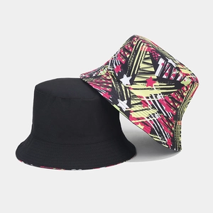 Close-up of reversible bucket hats set in solid black and vibrant graffiti print