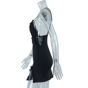 Detail of black lace trim and side slit on bodycon slip dress with sheer back