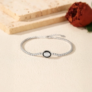 Elegant S925 sterling silver tennis bracelet with black enamel and oval crystal focal point