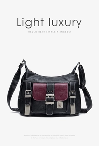 Detail of lychee textured leather saddle bag with contrast stitching and metal buckles
