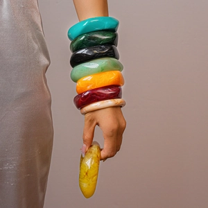 Close-up of vibrant marbled resin bangles showing diverse colors and thick smooth texture