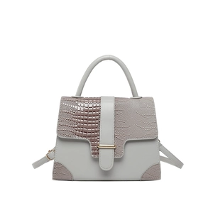 Light gray crocodile texture handbag with asymmetrical flap and adjustable shoulder strap