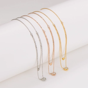 Minimalist double heart pendant necklace in gold, rose gold, and silver finishes